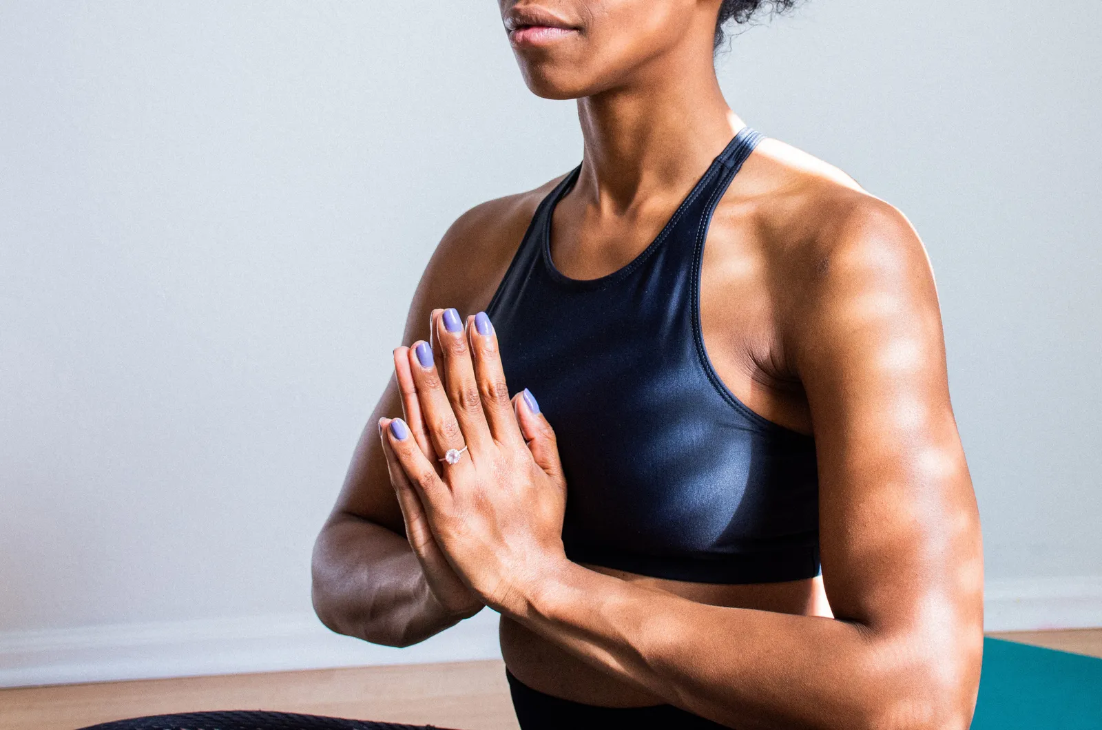A woman meditating with her eyes closed, focusing on positive emotions