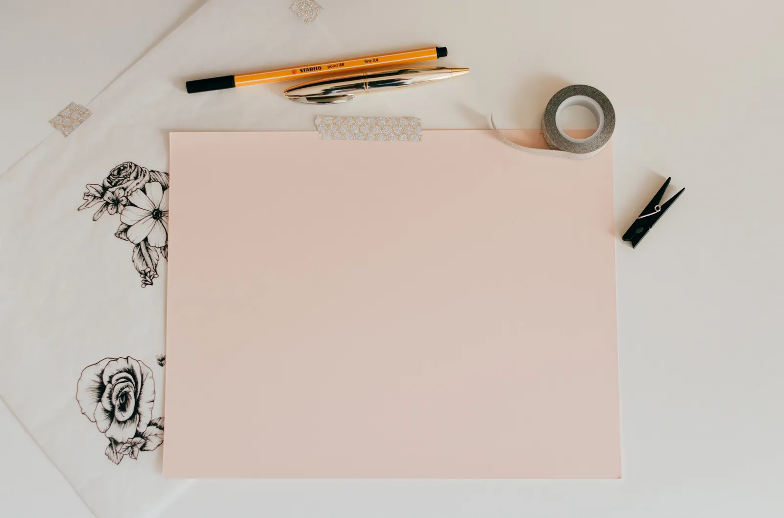 High-quality vision board materials — blank paper, a pen and washi tape on a desk