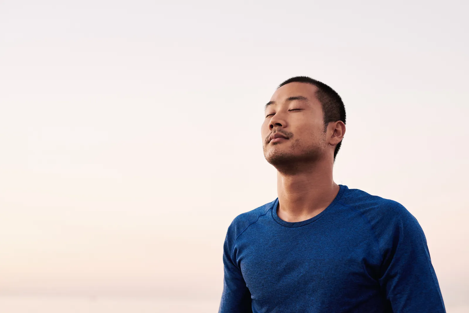 A person visualising their goals with eyes closed