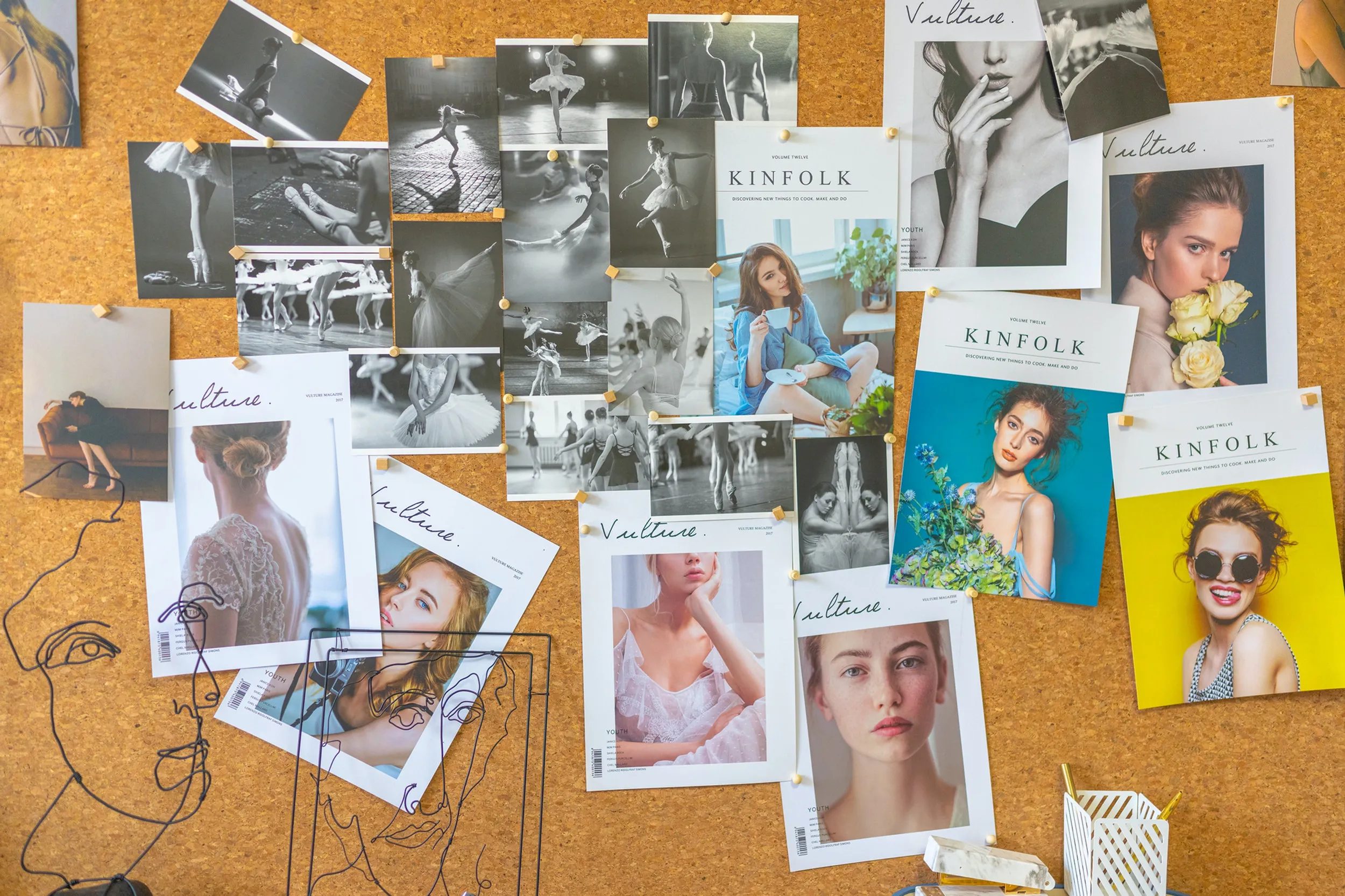 Cork mood board layered with black-and-white ballet photos and Kinfolk and Vulture magazine covers