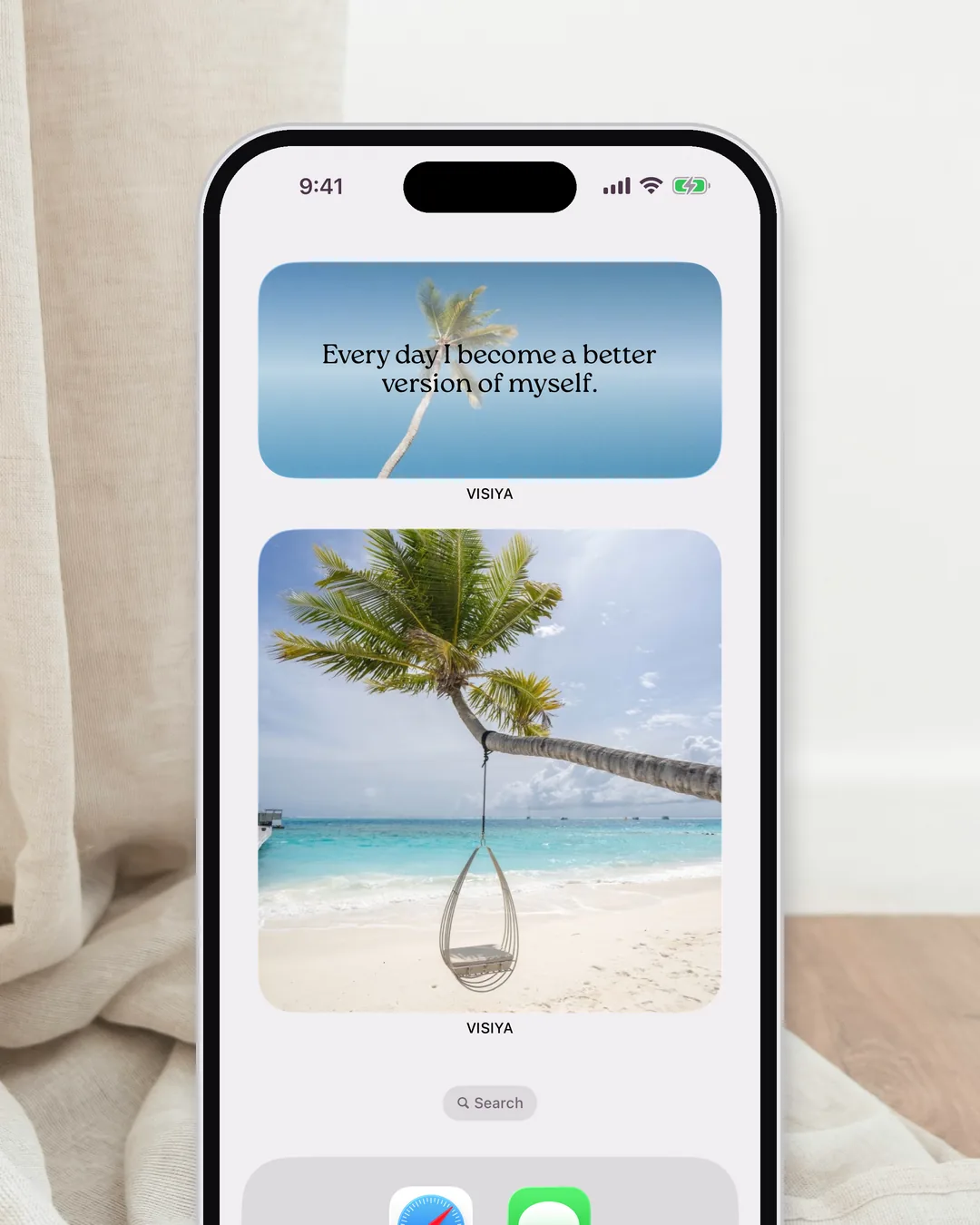 An iPhone home screen with the VISIYA vision board widget below the daily affirmation widget
