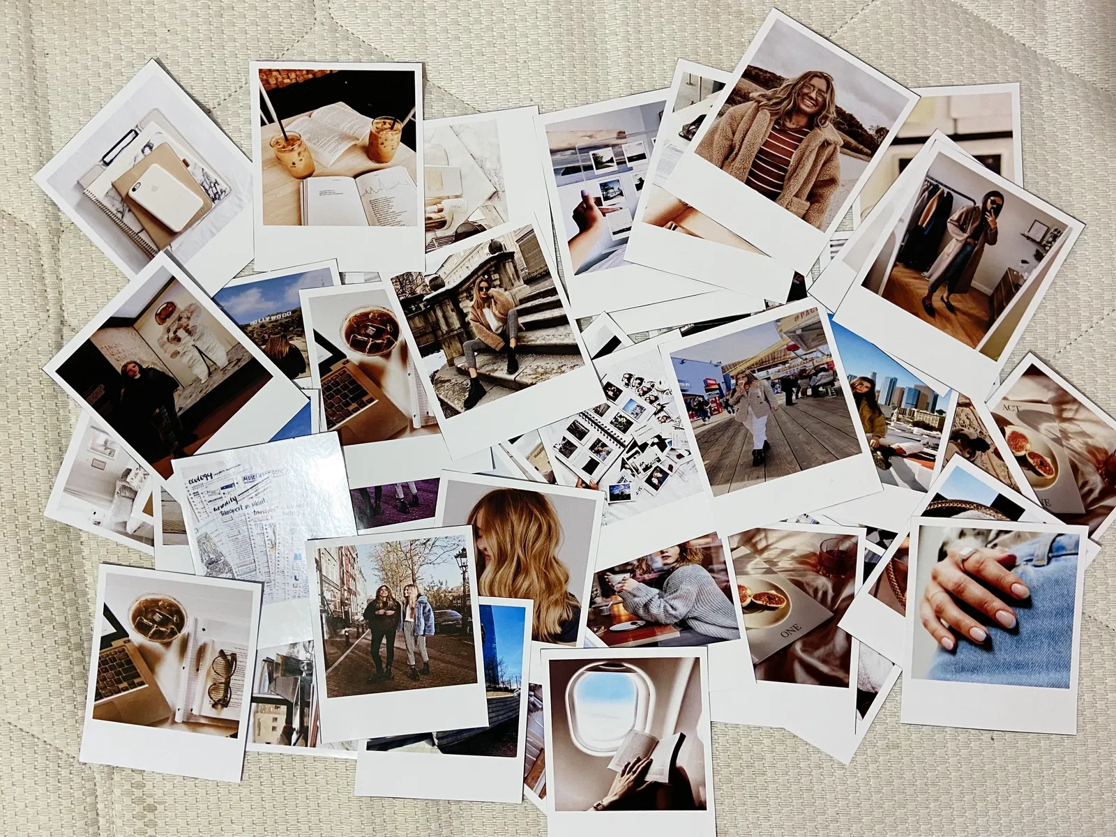 Polaroid photos spread out to choose images for a vision board