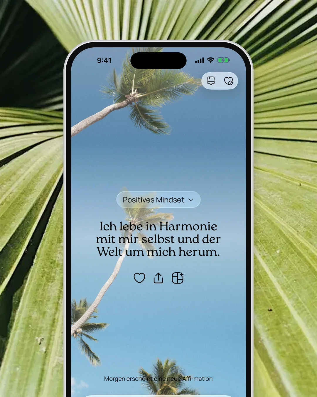 Eine Affirmation in der VISIYA App vor Palmen und Himmel, umrahmt von grünen Palmblättern