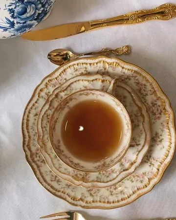 A cup of tea on a floral saucer